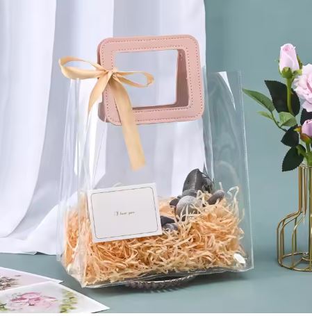 BOLSA ASA CUADRADA CUERINA ROSADA - PVC TRANSPARENTE 24.5x27.5x14