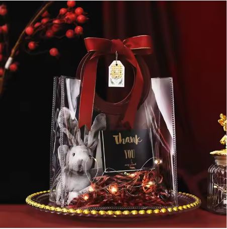 BOLSA ASA REDONDA CUERINA VINO - PVC TRANSPARENTE 24.5x27.5x14